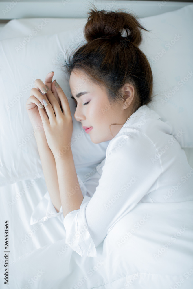 Beautiful young woman lying down in the bed and sleeping. Beautiful young woman lying down in the bed and sleeping.