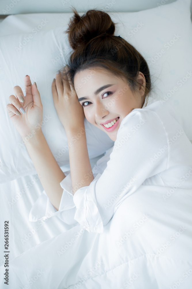 Beautiful young woman lying down in the bed and sleeping. Beautiful young woman lying down in the bed and sleeping.