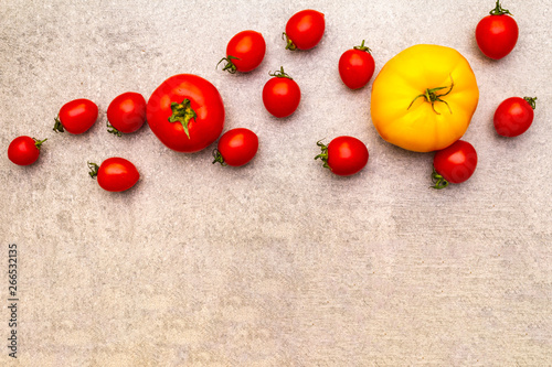 Fresh organic tomatoes. Food cooking stone background. Healthy vegetarian (vegan) eating concept, close up, top view, flat lay, copy space.