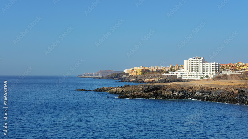 Summer, clear vistas towards San Blas and Golf del Sur, popular southern resorts in Tenerife, as seen from Playa Grande, in the small fishermen village of Los Abrigos, Tenerife, Canary Islands