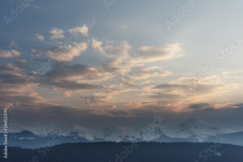 Rest on a mountainous valley with a view of the snow-capped peaks of Ukrainian carpathians in the spring period. 