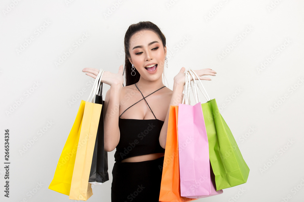 Portrait of happy smiling woman hold shopping bag