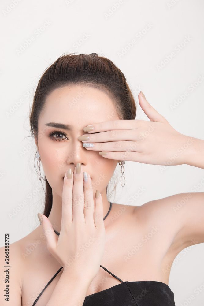 Beautiful woman face. Hand of make-up