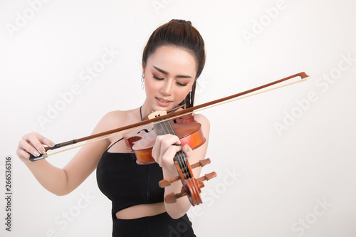 Beautiful young woman playing violin over white background
