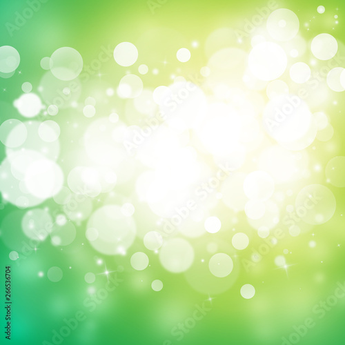 Green and Gold sparkle rays lights with bokeh elegant abstract background. Dust sparks background.