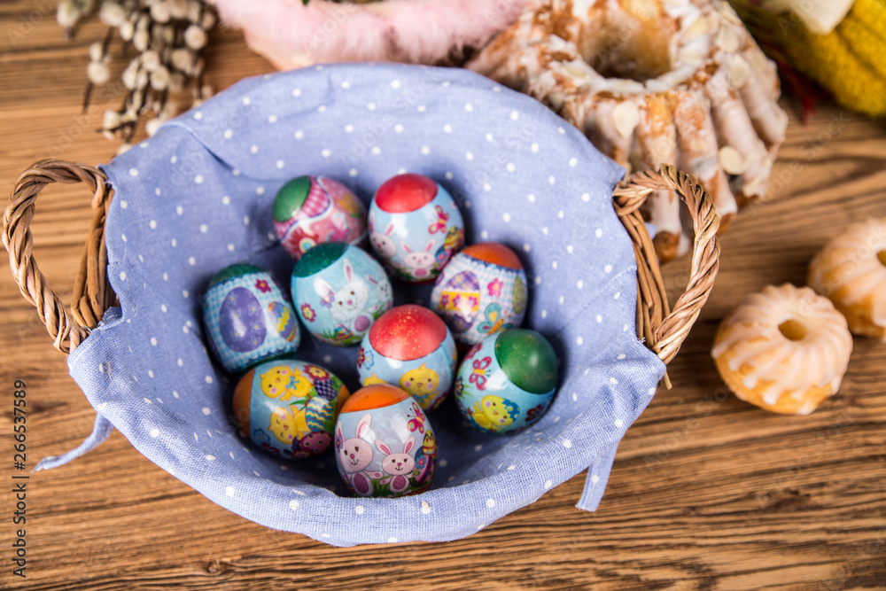 Easter. Colorful palms and base. Foods for Easter candles. Eggs and basket. Easter cake