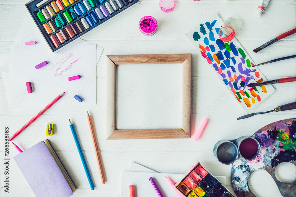 Top view Bright workplace of creative artist mockup. Blank canvas surrounded by variety of drawing supplies. Art, workshop, painting, drawing, inspiration, craft, creativity concept. Art therapy, - obrazy, fototapety, plakaty 
