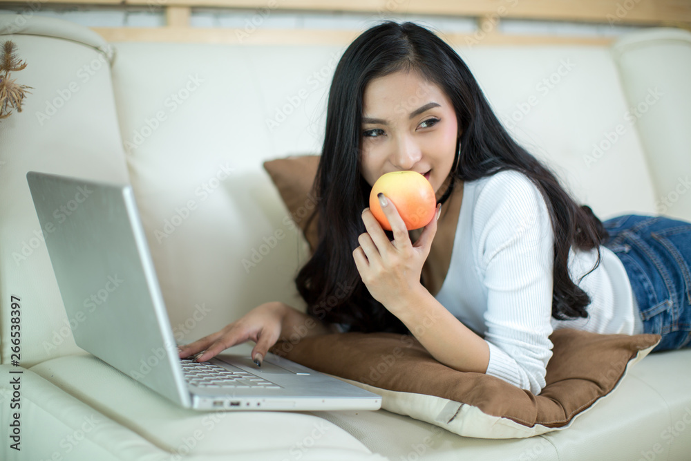 Young beautiful woman using a laptop computer at home. Young beautiful woman using a laptop computer at home.