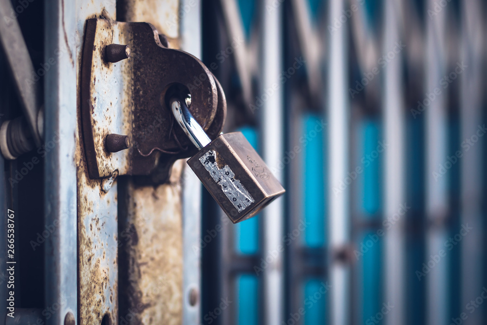 steel padlock with brass key lock on metal door steel padlock with brass key lock on metal door
