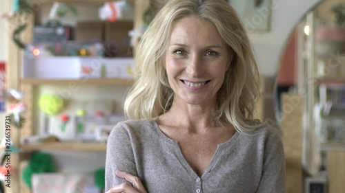 Wallpaper Mural Medium shot of portrait mature woman standing with arms crossed in shop Torontodigital.ca