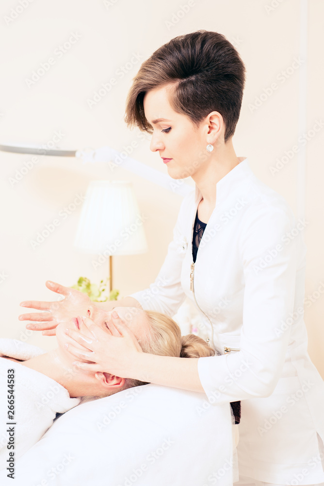 Beautician makes facial massage. cosmetology cabinet. skin care. healthy lifestyle concept. Beautician makes facial massage. cosmetology cabinet. skin care. healthy lifestyle concept.