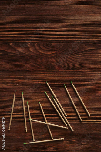 Toothpicks are loose on a wooden table