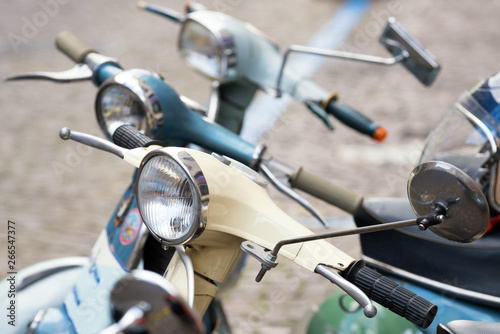 Three Italian vintage scooters parked