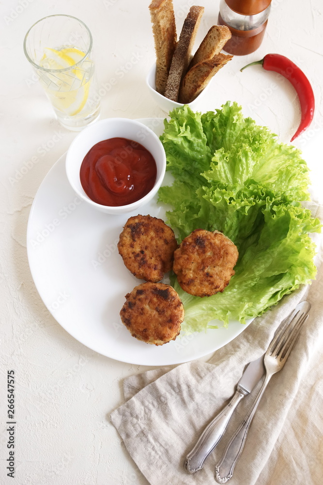 Homemade fried chicken meat cutlets with salade leaves , lettuce and sauce top view