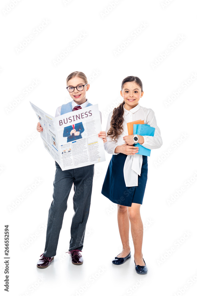 happy schoolgirls in formal wear with business newspaper and books On White happy schoolgirls in formal wear with business newspaper and books On White