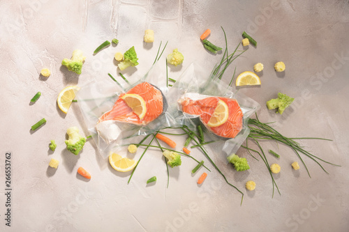 Sous Vide cooking concept. Vacuum packed ingredients arranged on light background. photo