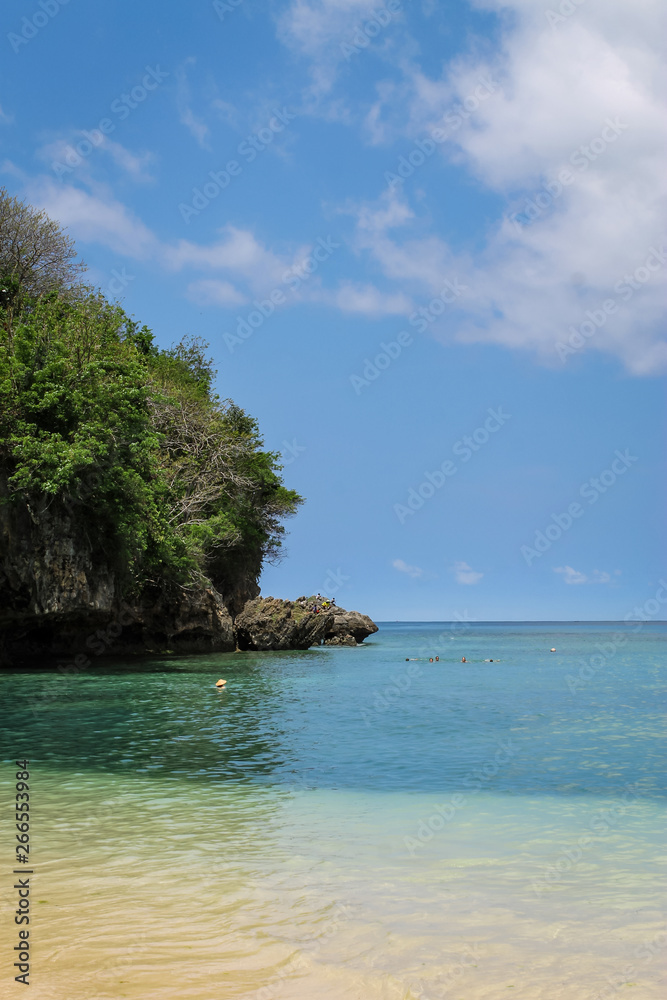 Fototapeta premium PADANG PADANG BEACH, ULUWATU, BALI, INDONESIA - November 30, 2013: View of Padang Padang Beach with pristine waters and blue skies.