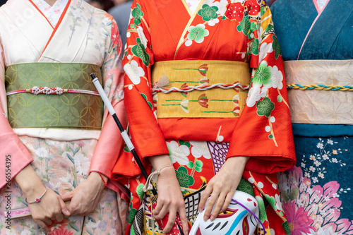 Fotografie, Tablou Young girl wearing Japanese kimono standing in front of Sensoji Temple in Tokyo, Japan