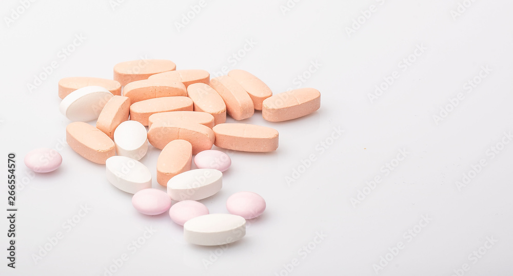 medical pink and white pills and capsules with medicine are on a white background medical pink and white pills and capsules with medicine are on a white background