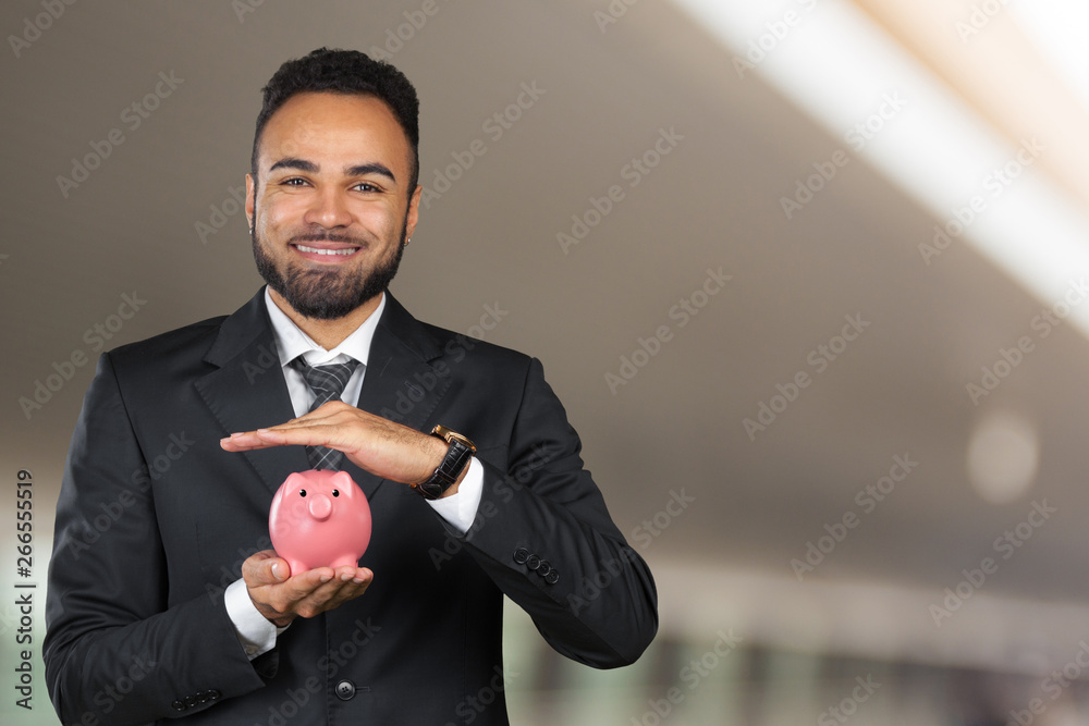 Εκτύπωση καμβά African American business man holding a piggy bank