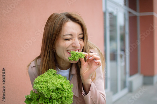 Portrait of young beauty woman eating salad