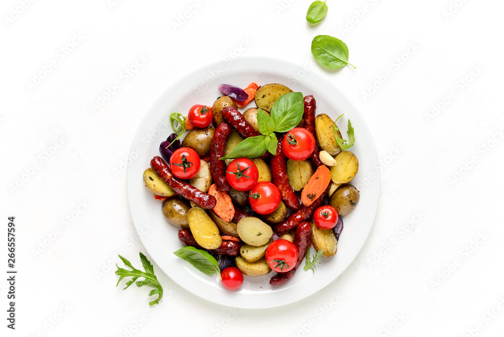 Sausages roasted with vegetables, view from above Sausages roasted with vegetables, view from above