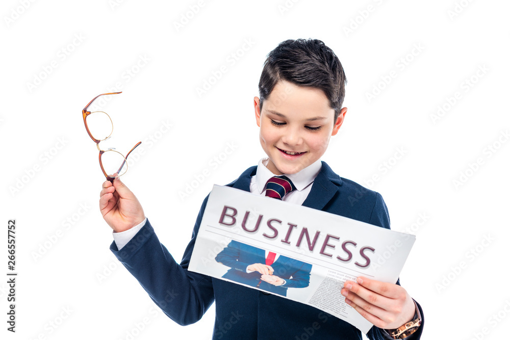 schoolboy in formal wear with glasses reading business newspaper Isolated On White schoolboy in formal wear with glasses reading business newspaper Isolated On White