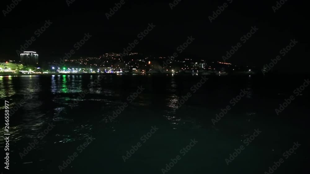 Panorama view of Yalta town from the Black sea. Night life on embankment. Crimea Panorama view of Yalta town from the Black sea. Night life on embankment. Crimea