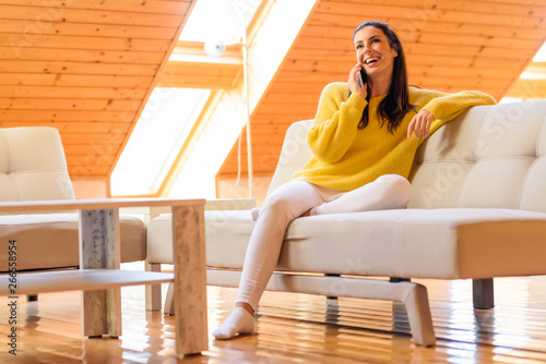 Portrait of a beautiful woman talking on the phone while relaxin photo