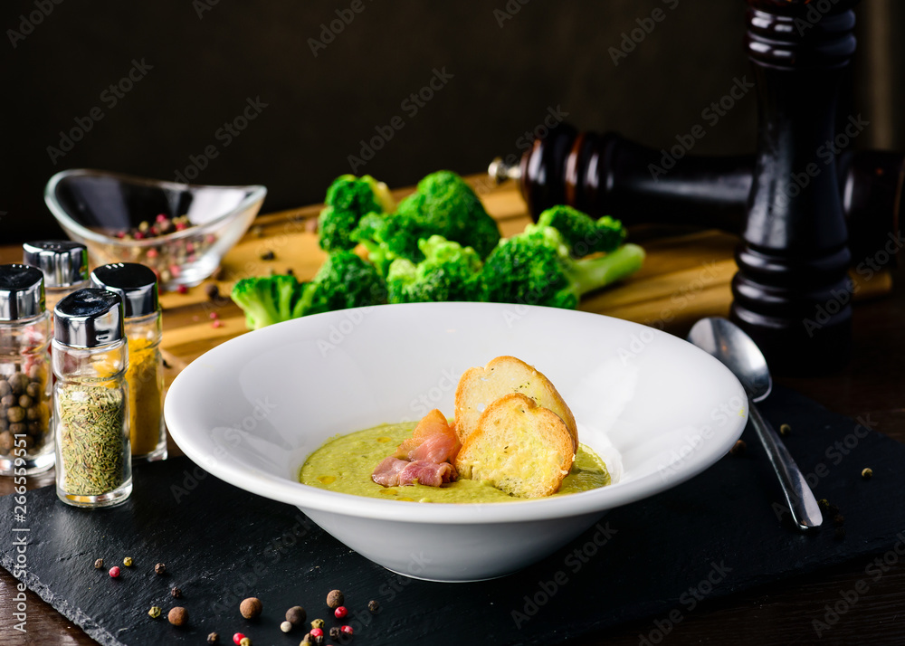Broccoli cream soup with bread on a table. Classic European food Broccoli cream soup with bread on a table. Classic European food