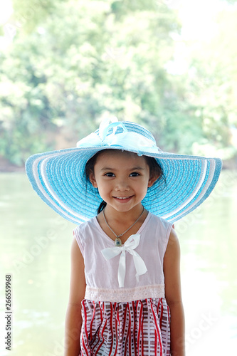 Little Asian Girl outdoors in summer hat