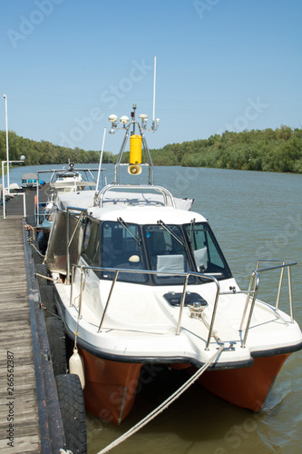 boats neat the berth on Dunau river, green water, summer day photo