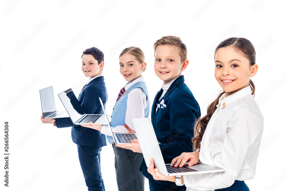 happy schoolchildren pretending to be businesspeople using laptops and looking at camera Isolated On White