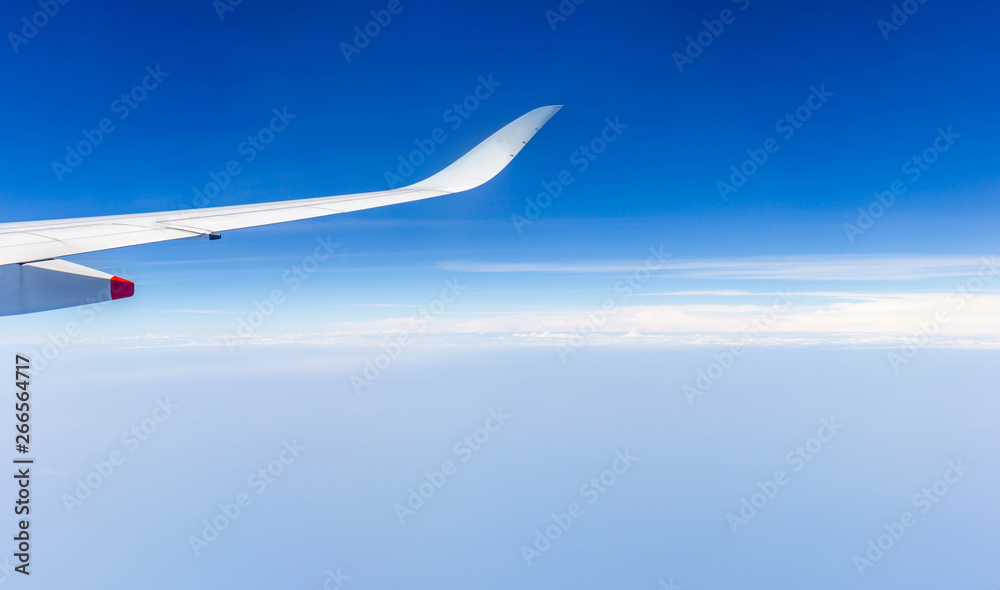 Airplane wing view out of the window the cloudy sky background, Travel and Holiday vacation concept Airplane wing view out of the window the cloudy sky background, Travel and Holiday vacation concept