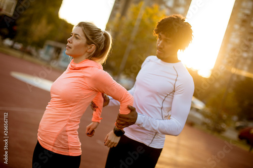 Personal trainer helping wo...