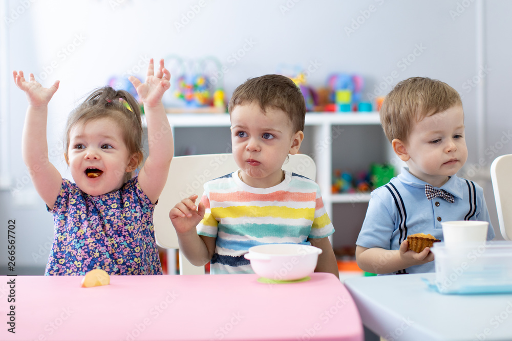 Group of children have a lunch in daycare centre. Kids eating in kindergarten Group of children have a lunch in daycare centre. Kids eating in kindergarten