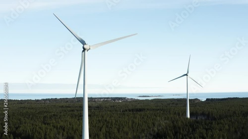 Wallpaper Mural Still flyuing drone films two slow rotating windmills - blue skies background with very almost no white clouds, Northern Sweden, ecological energy production. Close to Umea city Torontodigital.ca