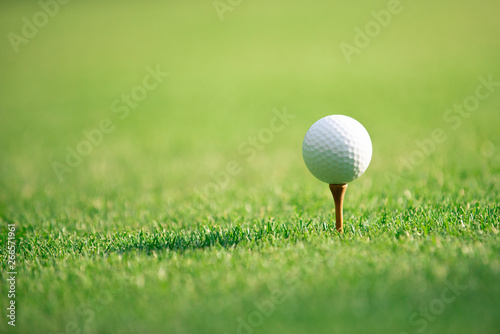 Close up on golf ball on tee at golf course ,Healthy Holiday Concept