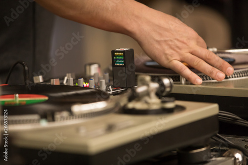 DJ hands mixing records on turntable