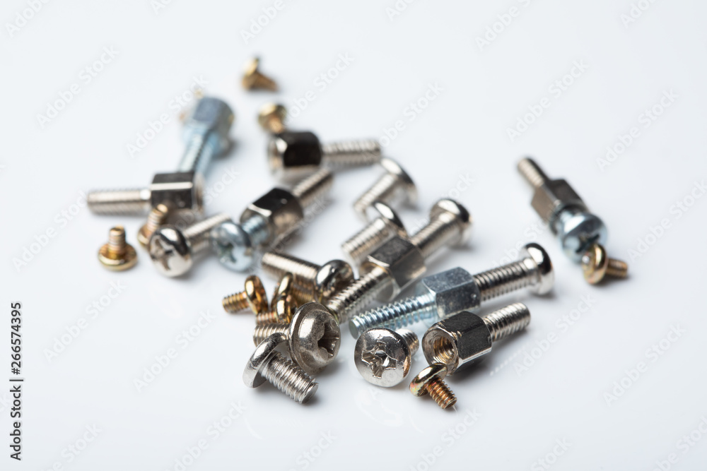 Pile of tiny screws used for circuit boards, close up Pile of tiny screws used for circuit boards, close up