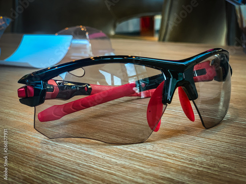 Black and red sunglasses Placed on the table blurry background