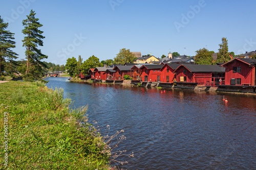 Beautiful city landscape with idyllic river and old red wooden shore warehouses at summer day in Porvoo, Finland