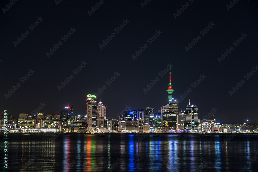 Auckland skyline at night reflecting in ocean