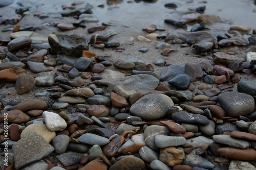 Pebble stones on the river shore. Closeup.