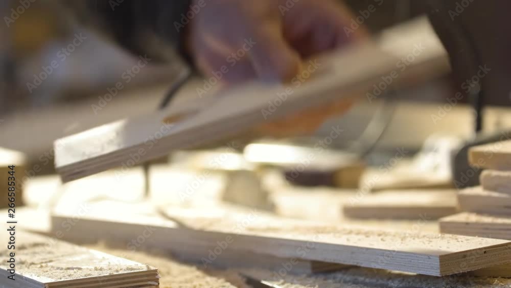 A man mills woodworker in a woodworking workshop, a carpenter in a respirator with a milling machine A man mills woodworker in a woodworking workshop, a carpenter in a respirator with a milling machine