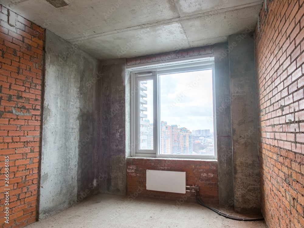 Fototapeta premium Concrete and brick walls in the apartment for repair