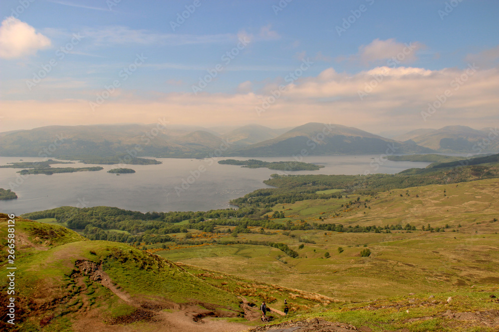 View of Loch Lomond in Scotland with blue sky and clouds in the background