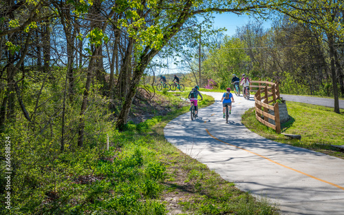 Fotografiet Family with kids biking on bike trail in Bella Vista, Northwest Arkansas