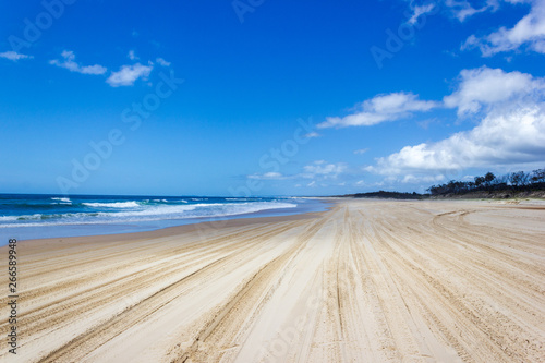 Main transportation highway on Fraser Island - wide wet sand beach coast facing Pacific ocean - long 75 miles beach