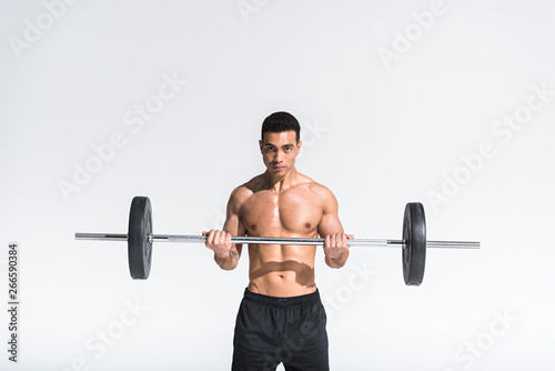 handsome athletic mixed race with muscular torso training with barbell on white